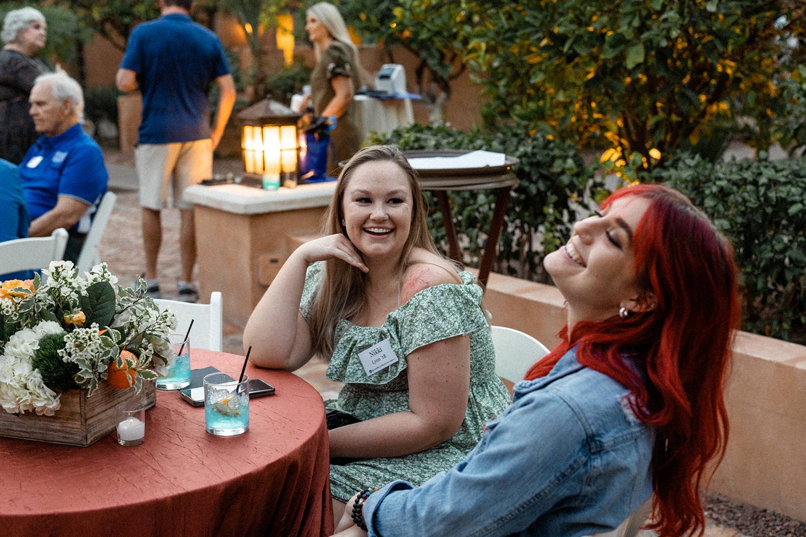 Two alums smile during an event in Phoenix